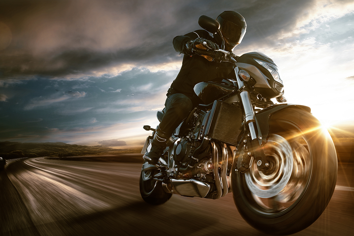 Man Riding a Motorcycle Down the Highway.